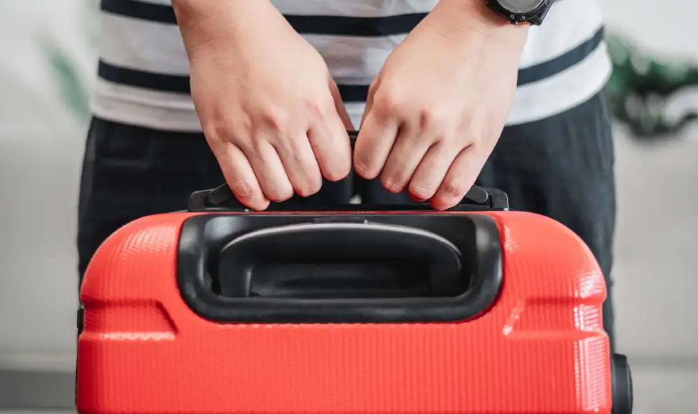 Man-holding-a-suitcase